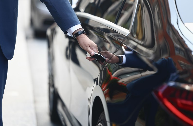 Chauffeur opening the door for a passenger